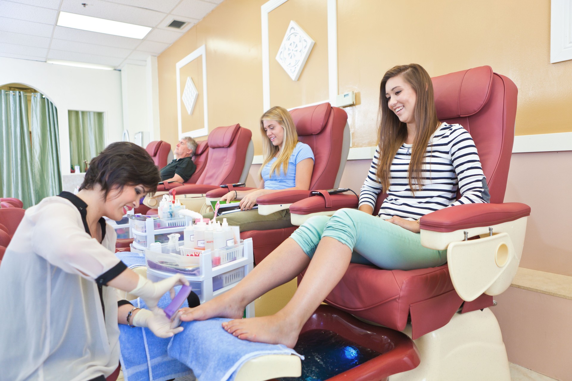 Manicurists and Pedicurists Serving Customers in Nail Spa Salon